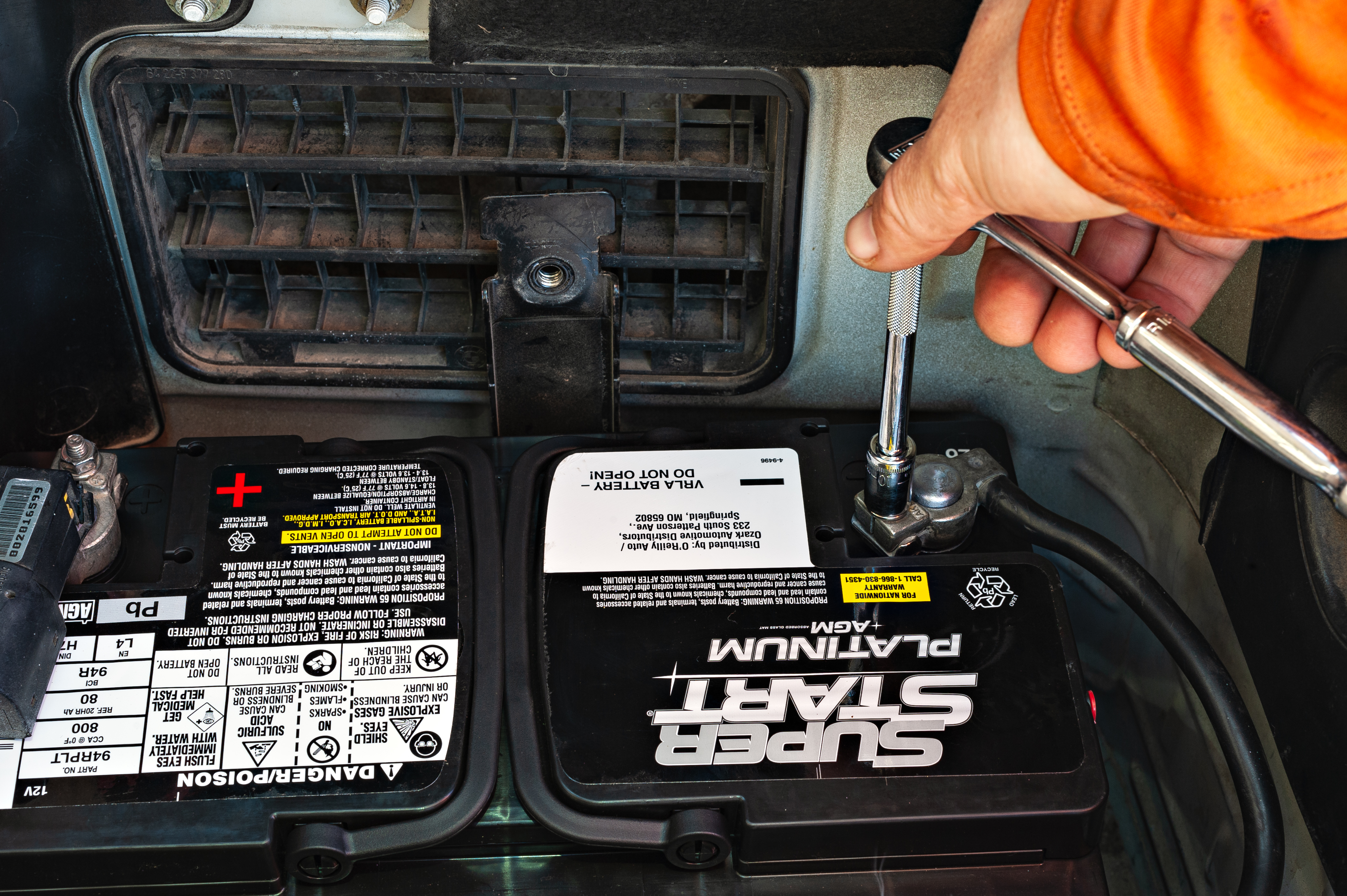 Mechanic replacing dead car battery at customer location Austin Texas